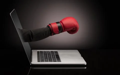 Hand with box gloves coming out of a laptop 스톡 사진