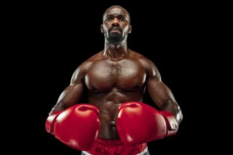 Hand of boxer over black background. Strength, attack and motion concept Stock Photos