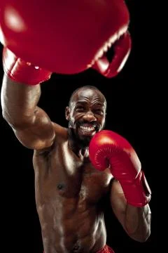 Hand of boxer over black background. Strength, attack and motion concept Stock Photos