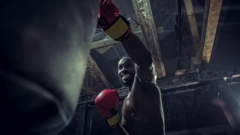 Hand of boxer over black background. Strength, attack and motion concept Stock Photos
