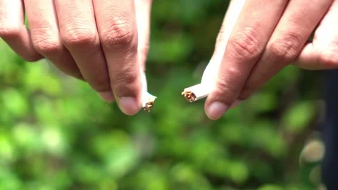 Hand Breaking Cigarette in Half – No Smoking Campaign Concept for World No Tobac Stock Footage 306735972