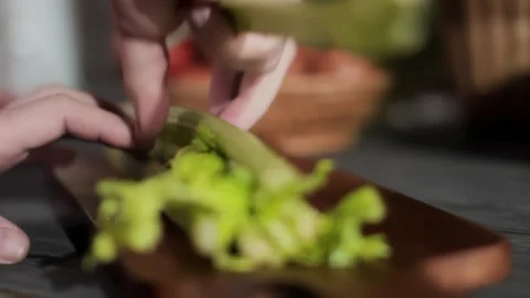 Hand breaking a fresh stalk from a celery bunch Stock Footage 312471514