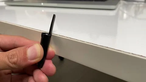 Hand breaking plastic pen cap flicking trick on white office table close up view Stock Footage 249307300