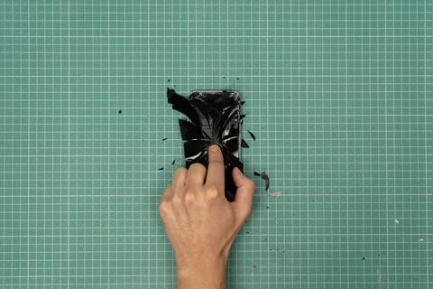 Hand breaking a smartphone. Stock Photos