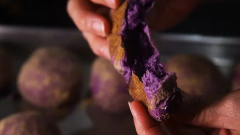 Hand Breaking An Ube Flavored Bread Stock Footage 328220680