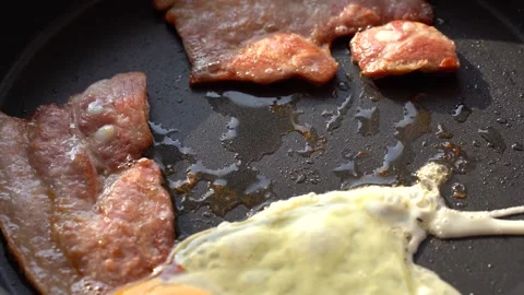 Hand breaks one egg into a pan Stock Footage 134605958