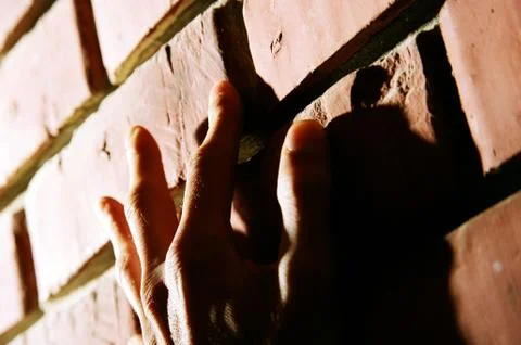 Hand on brick wall Stock Photos