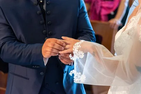 Hand of the bride putting the ring on the bride Stock Photos