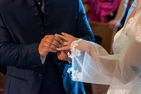 Hand of the bride putting the ring on the bride Stock Photos