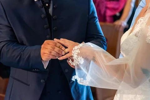 Hand of the bride putting the ring on the bride Stock Photos