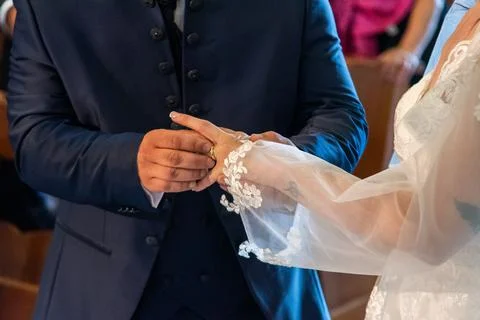 Hand of the bride putting the ring on the bride Stock Photos