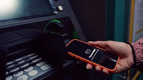Hand Bringing Smartphone to ATM While Payment Failure Icon Shows in a Close Angl Stock Footage 323464859