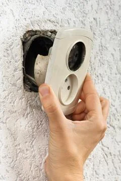 Hand with the broken electrical socket Stock Photos
