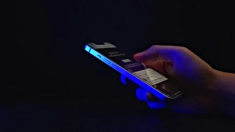 Hand Browsing Smartphone in Dark Room Stock Footage 277196105