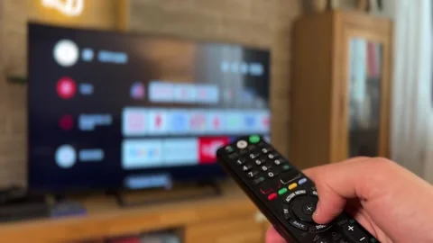 Hand Browsing Streaming Interface on TV Stock Footage 310139096