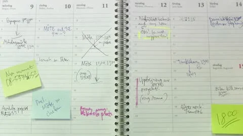 A hand browsing through an agenda with post-it notes Stock Footage 11286453