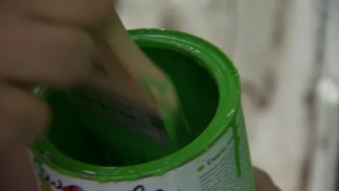 Hand with a brush. green paint is applied to a wooden door.  brush dipped Video stock 132048202