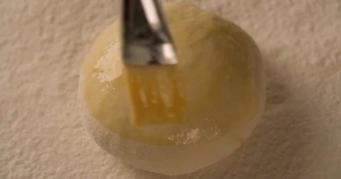 Hand with a brush lubricates dough pie cake with melange top view Stock Footage 102620176