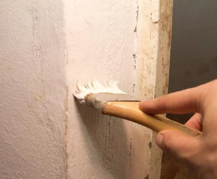 Hand with a brush, paint the wall Stock Photos