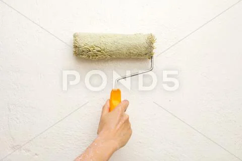 Hand with a brush, paint the wall Stock Photos