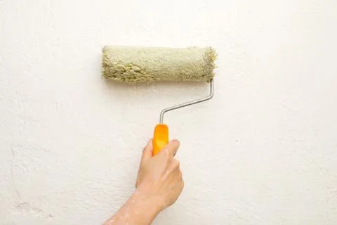 Hand with a brush, paint the wall Stock Photos