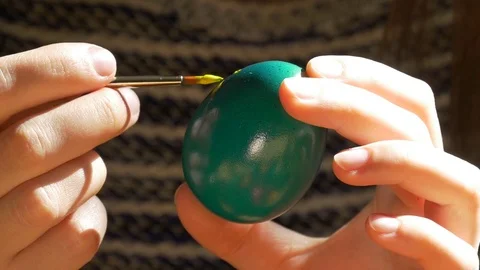 Hand with a brush paints an Easter egg Stock Footage 73456747