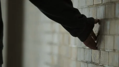 Hand brushing against the wall of an dingy factory Stock Footage 88052010