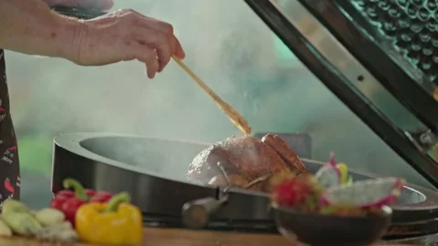 Hand brushing roasted whole chicken on a the grill bbq barbeque kamado camado Stock Footage 292808817