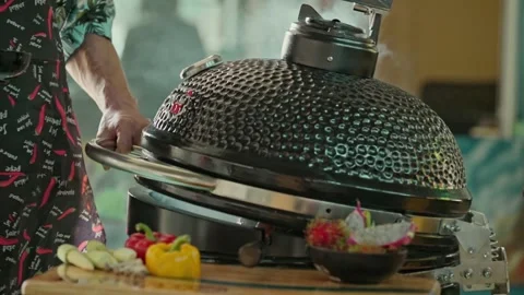 Hand brushing roasted whole chicken on a the grill bbq barbeque kamado camado Stock Footage 292809644