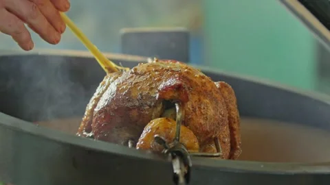 Hand brushing roasted whole chicken on a the grill bbq barbeque kamado camado Stock Footage 292811502