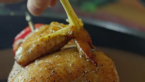 Hand brushing roasted whole chicken on a the grill bbq barbeque kamado camado Video stock 292812255