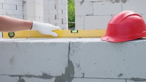 The hand of the builder measures the level of the plane using the building level Stock Footage 157548534
