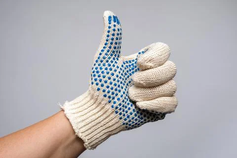 Hand of a builder, worker wearing construction safety protection glove showin Stock Photos