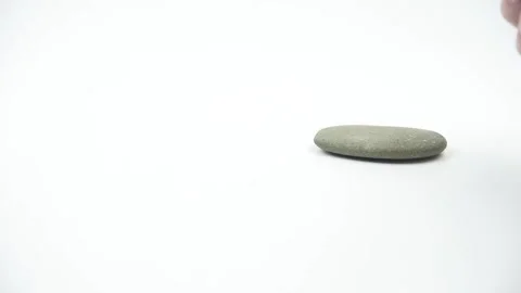 Hand building pyramids of gray zen pebble hot stones Stock Footage 143777889