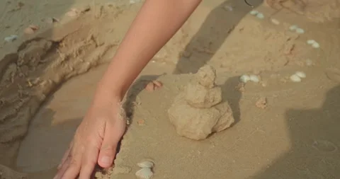 Hand building sandcastle on beach close up Stock Footage 333932487