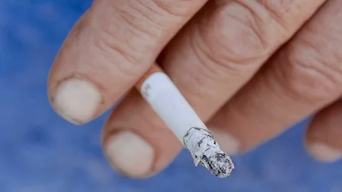 Hand with a burning cigarette Stock Footage 79136263