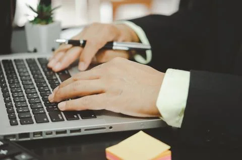 Hand business man is typing on a computer keyboard. Stock Photos
