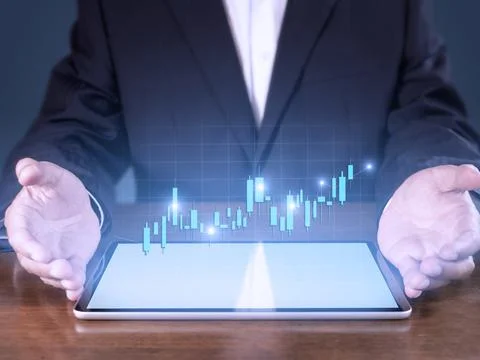 Hand of businessman present tablet analysis stock market graph growth and inc Stock Photos