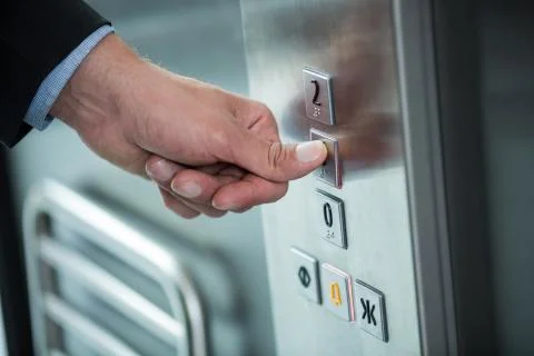 Hand of a businessman pressing the button in an elevator Foto stock