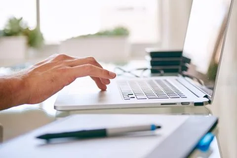 Hand busy operating the touchpad on a notebook Stock Photos