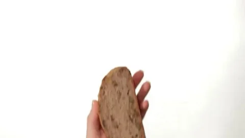 Hand Buttering a Slice of Bread on white background Stock-Footage 98247643
