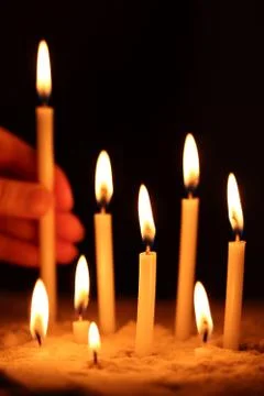 Hand with candle Stock Photos