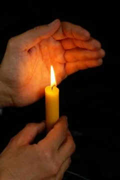 Hand with candle Stock Photos