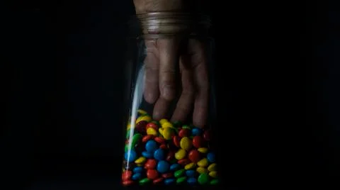 Hand in the Candy Jar Low Key Stock Photos