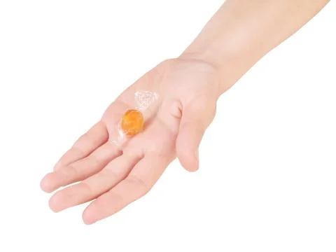 Hand with candy. On white, clipping path included Foto stock