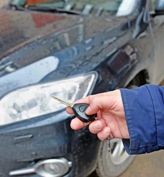 Hand with car key Stock Photos