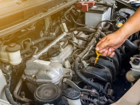 Hand of car mechanic working in auto repair service. He have fix old car Stock Photos