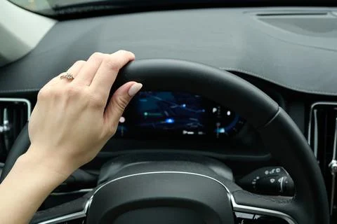 Hand on car steering wheel while driving — interior view Stock Photos
