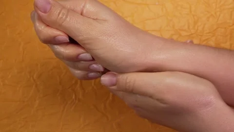 Hand care concept. Side view shot of unrecognizable female hands rubbing Stock Footage 263744551