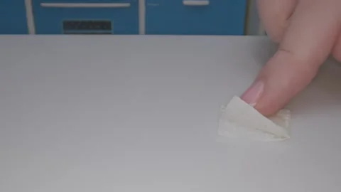 Hand carefully cleans a miniature surface in a tiny kitchen while filming a Video stock 286889195